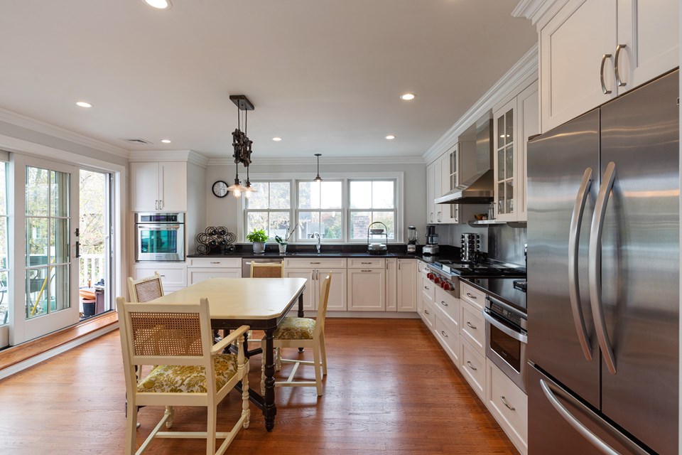 another view of the eat-in kitchen and the balcony with a grill and an optional dining area