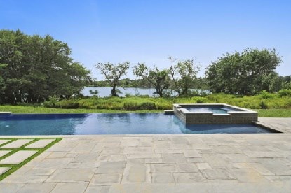 infinity edge pool, spa and patio overlooking pond