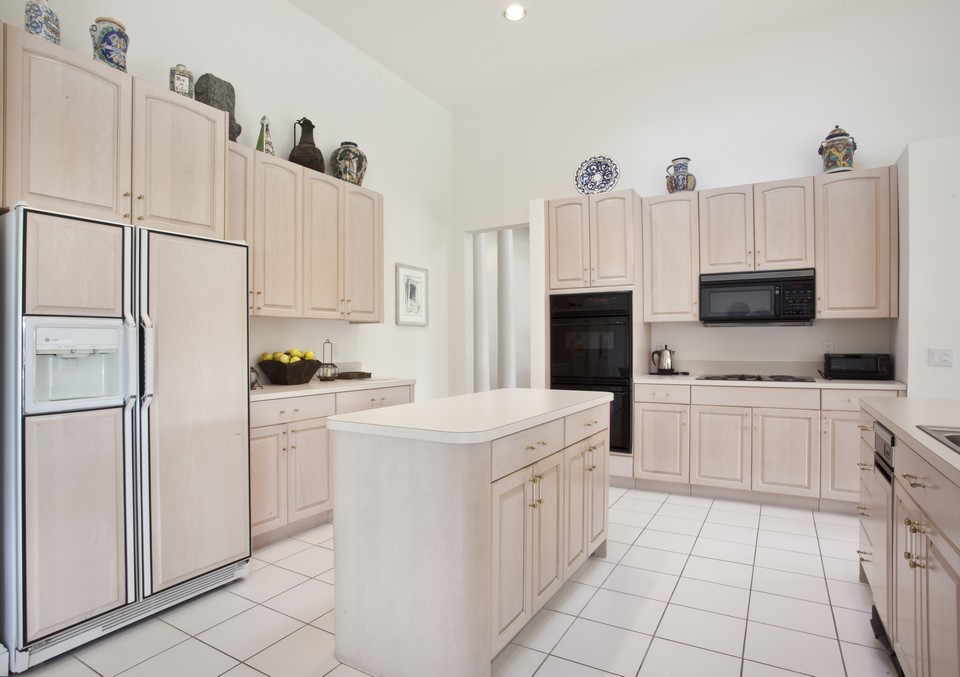 clean and crisp kitchen has all the right accoutremonts