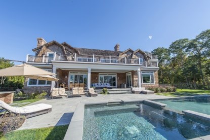 rear exterior with pool and spa