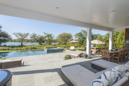 wide porch overlooking pool and pond